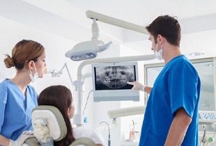 dentist showing a patient their dental X-rays