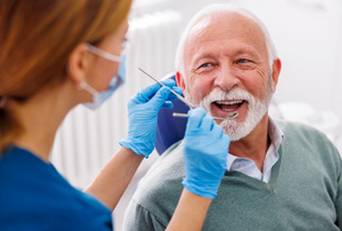 Man smiles at dentist