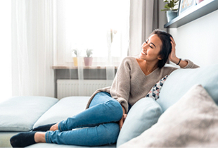 happy person lounging on their couch