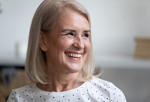 woman smiling after getting dental implants in Arcadia