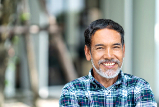 person smiling and standing outside