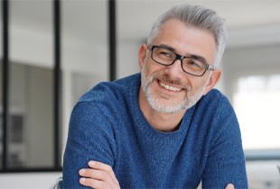 man smiling after getting dental implants in Arcadia