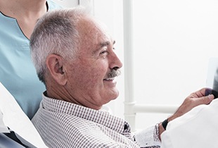 Smiling older man in dental chair