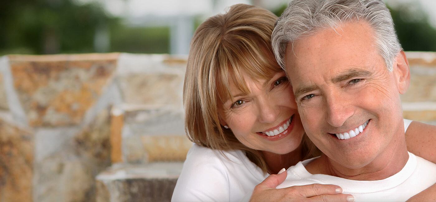 Older man and woman smiling together