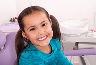 Smiling little girl in dental chair