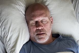 Man sleeping soundly in bed