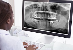Dentist looing at dental x-rays