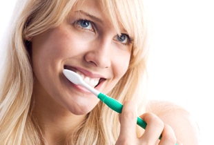 young woman brushing teeth