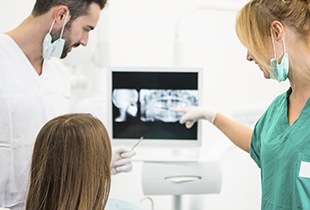 Dentist and patient looking at x-rays